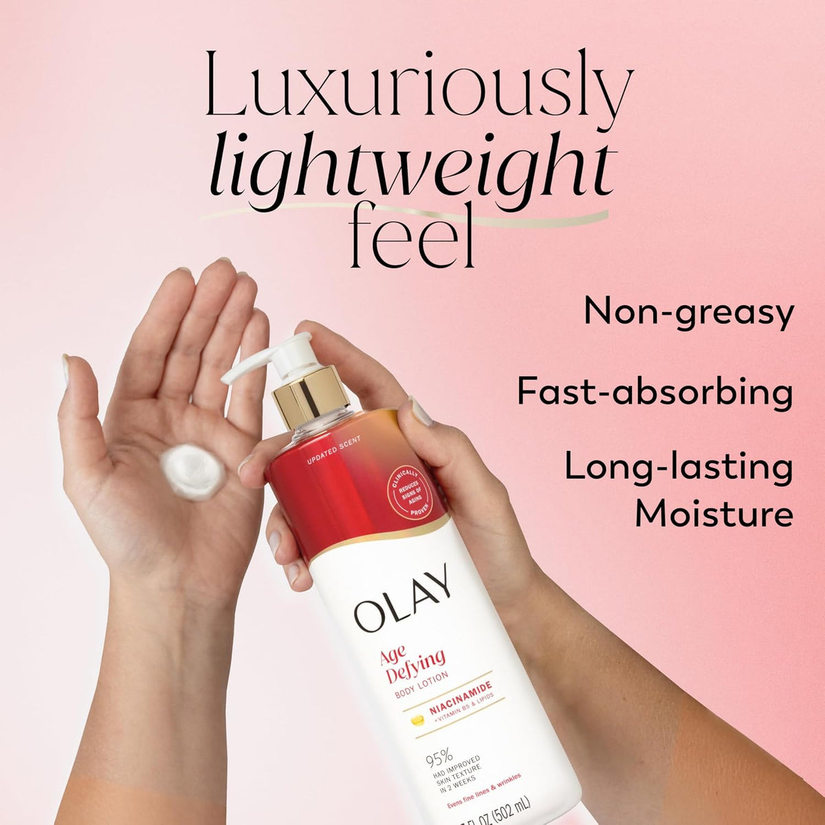 OLAY Age Defying moisturizer bottle with hands holding it against a pink background