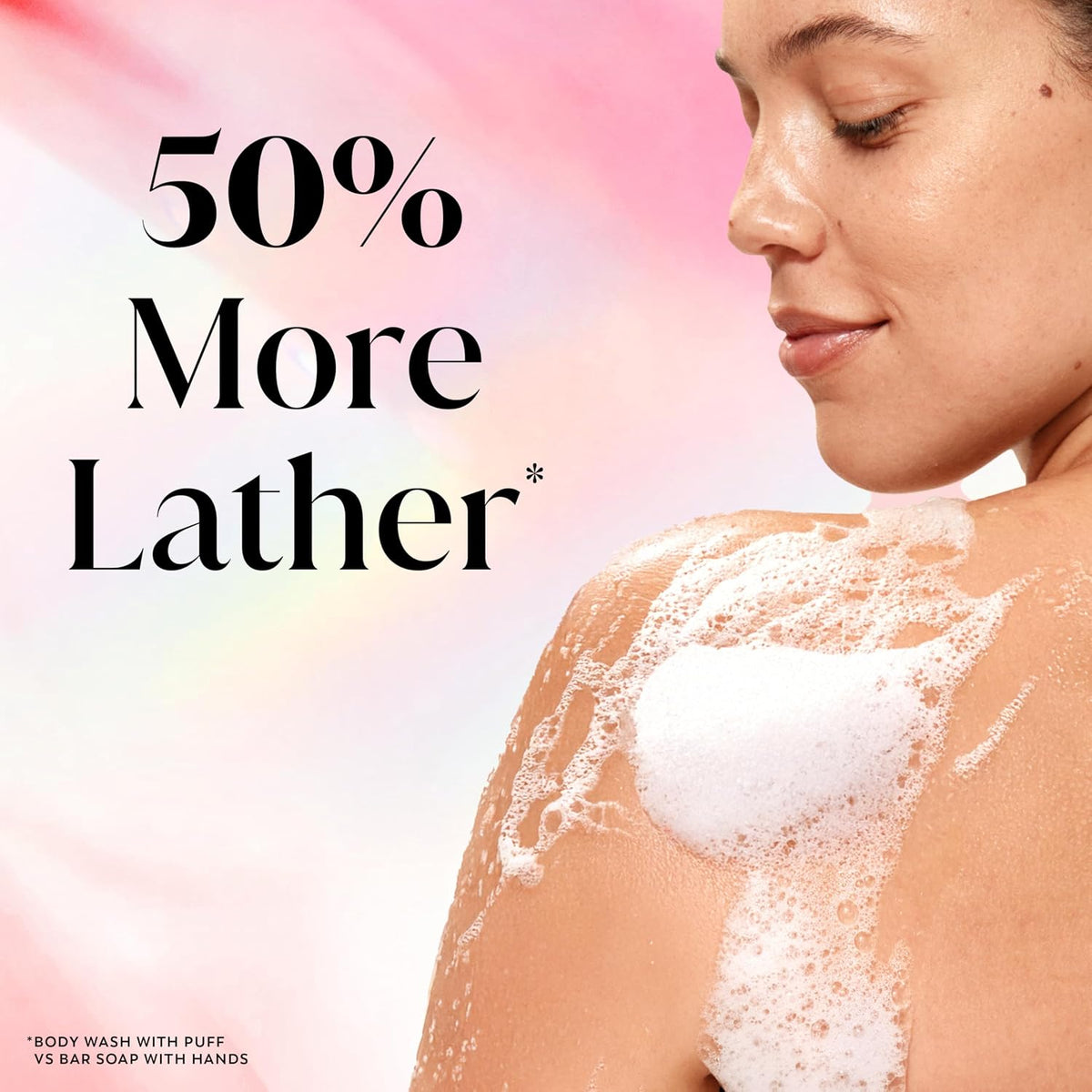 A woman with white foam on her shoulder and upper back is shown against a soft pink and white background with large text reading '50% More Lather'. Small text at the bottom left says the wash is with puff vs bar soap with hands.