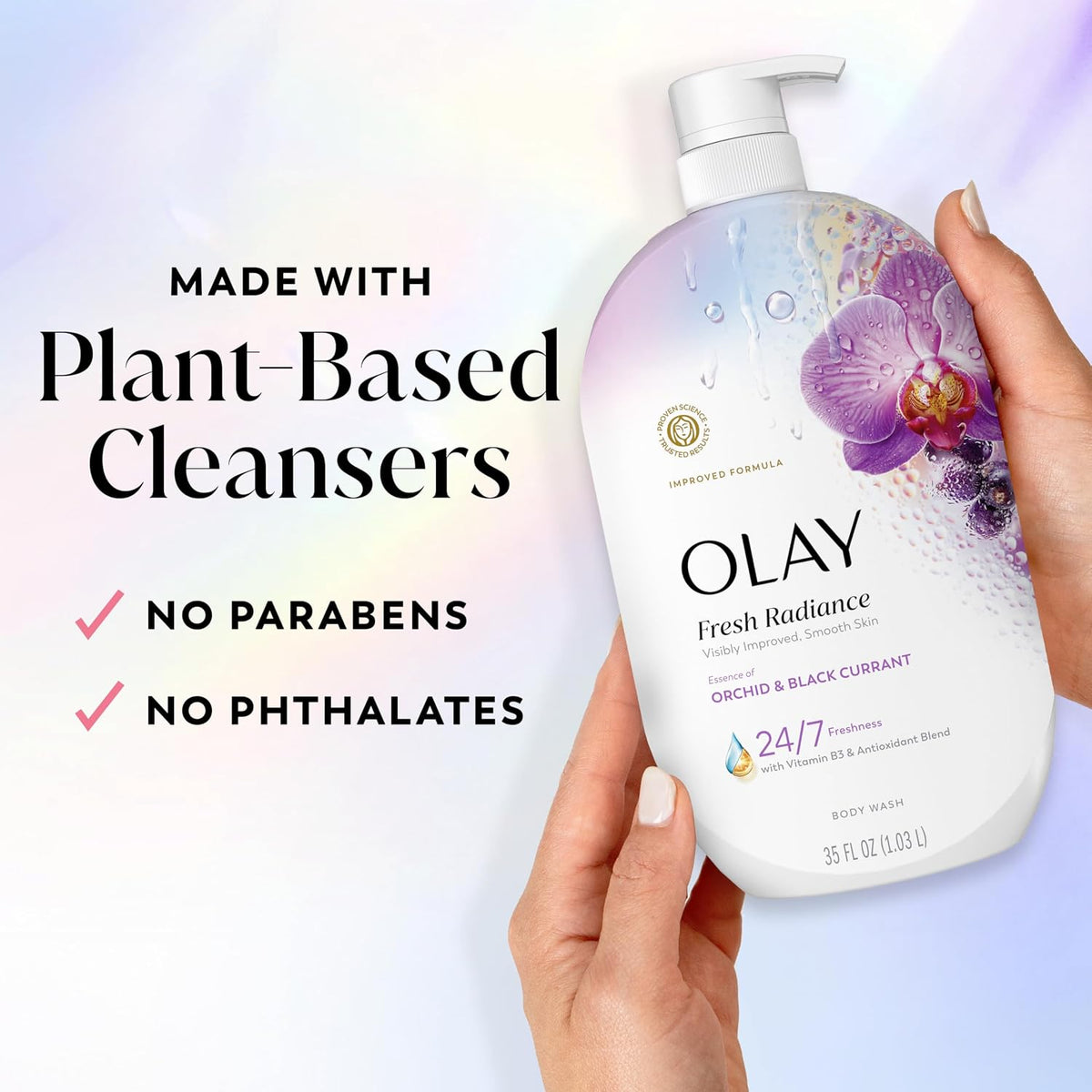 Olay body wash bottle held by a hand with plant-based cleanser information on a gradient background