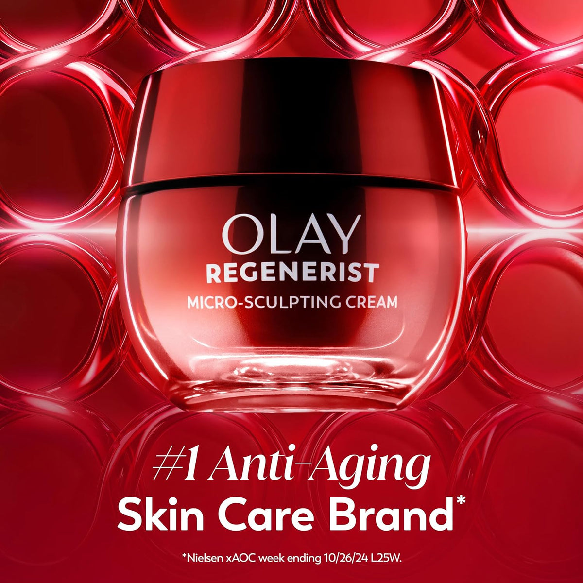 Olay Regenerist Micro-Sculpting Cream jar centered against a glossy red abstract background with circular highlights. White text on the jar reads 'OLAY REGENERIST MICRO-SCULPTING CREAM.