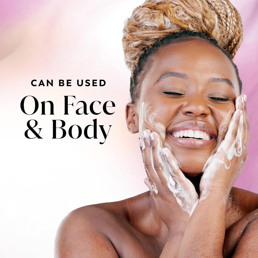 A smiling woman with white foaming body wash on her face and hands, set against a soft pink and white background with the text 'CAN BE USED On Face & Body'.