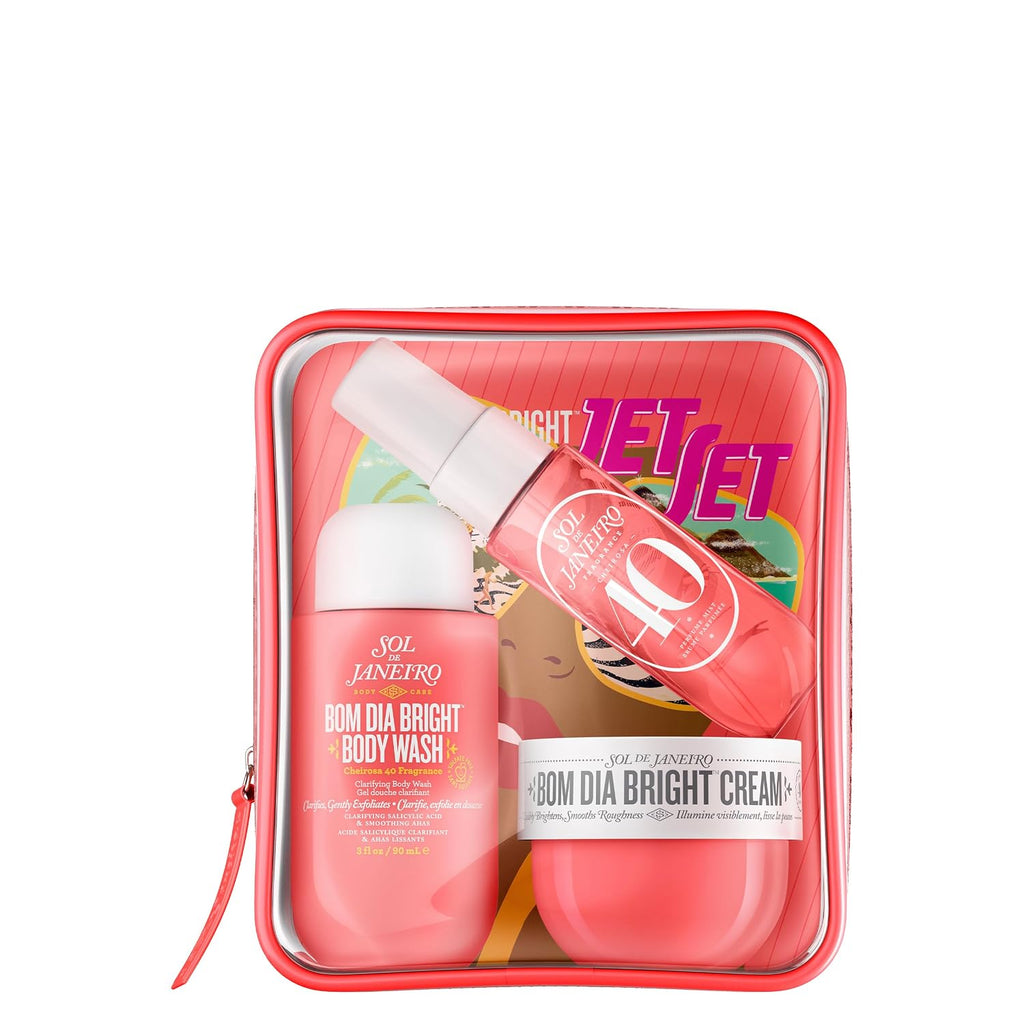Skincare product set with 'Bom Dia Bright' cream, lotion, and body wash in a pink travel case on a white background.