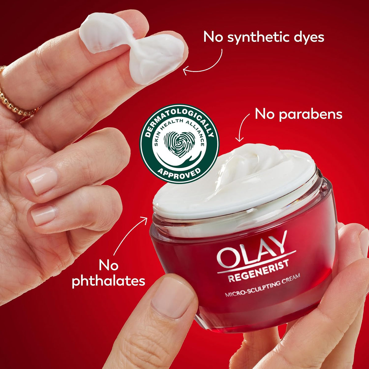 Olay Regenerist cream jar with hand holding cream, red background, and approval logo.