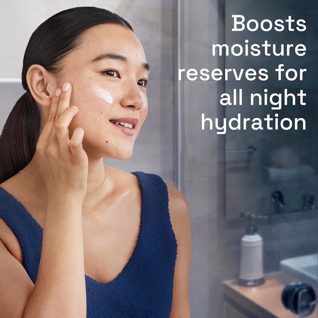 Woman applying cream to her face with a bathroom background