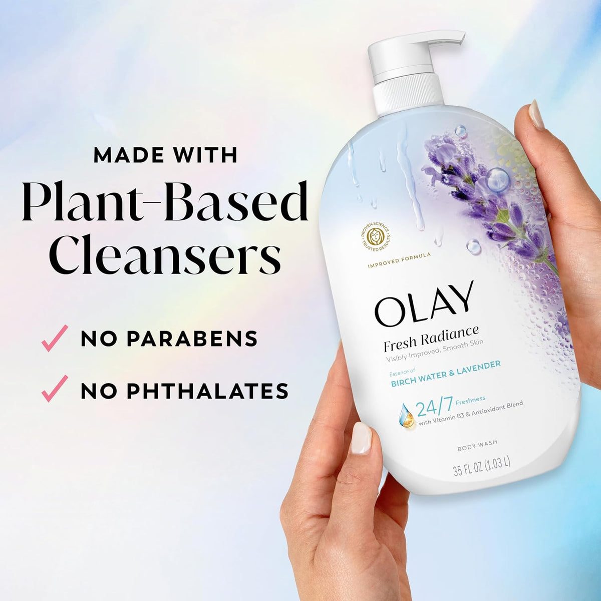 Olay body wash bottle held by a hand with product details on a gradient background