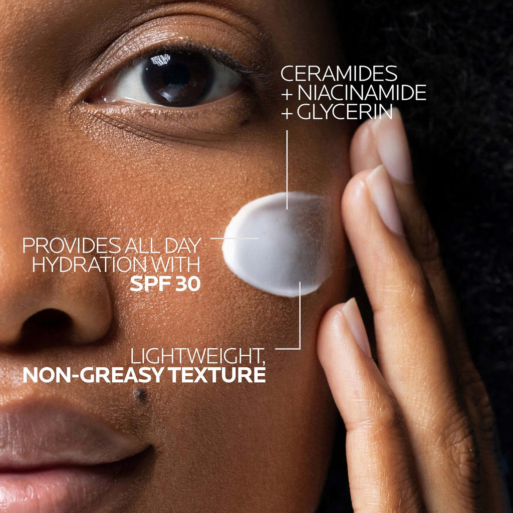 Close-up of a person applying cream to their face with product details.