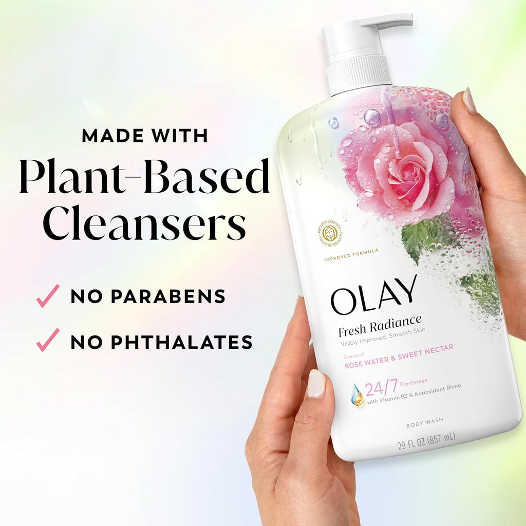 OLAY body wash bottle held by a hand with plant-based cleanser information on a light background
