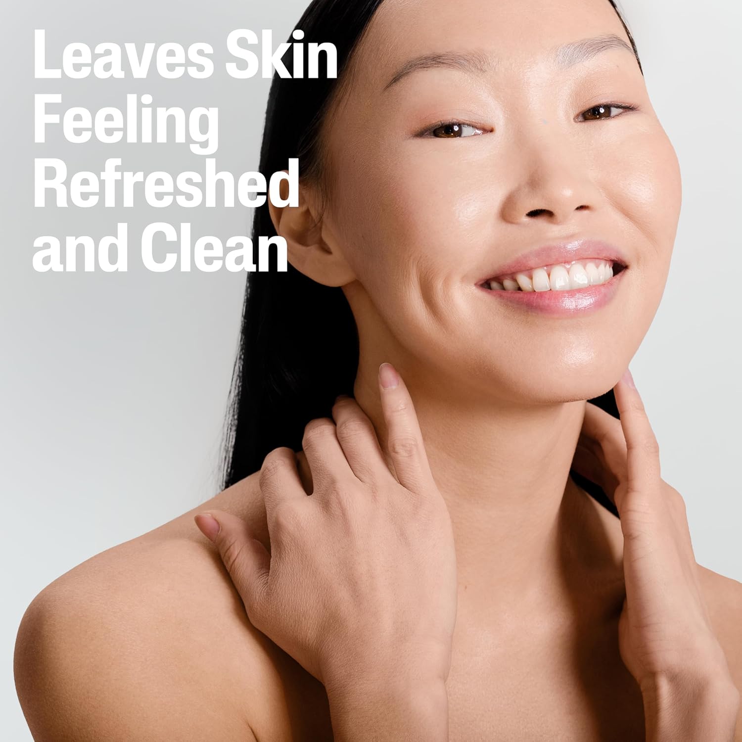 Woman touching her face with a text overlay 'Leaves Skin Feeling Refreshed and Clean' on a light gray background