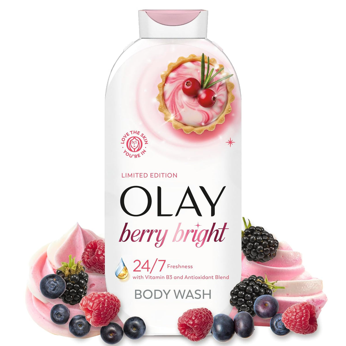 A bottle of Olay Berry Bright Body Wash centered on a white background, surrounded by pink whipped cream swirls and fresh berries including raspberries, blueberries, and blackberries. The bottle features a pink and white design with a berry tart illustration on the upper front.