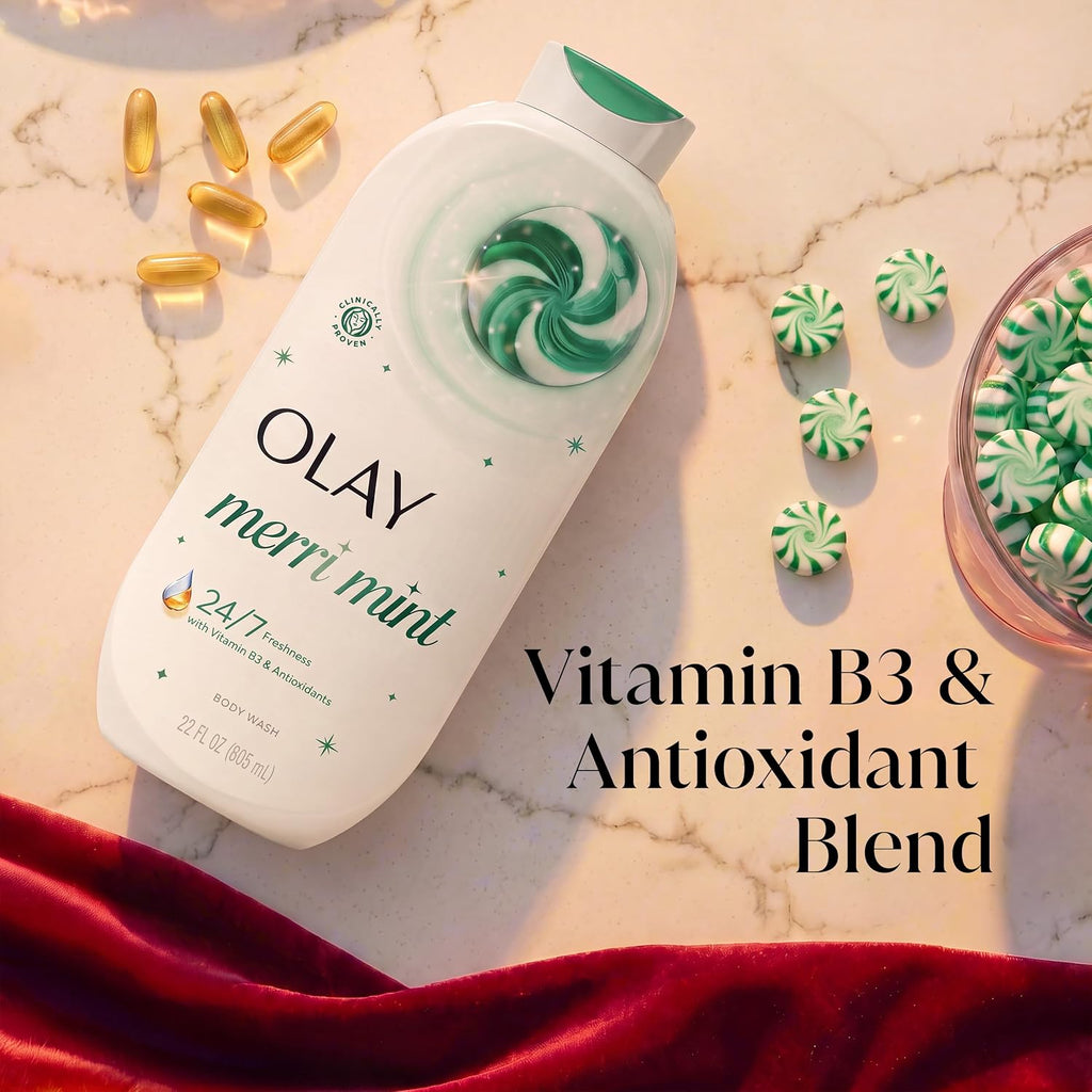 Olay Merri Mint body wash bottle on a marble surface with decorative mint candies, gold capsules, and a red velvet cloth. Text overlay reads 'Vitamin B3 & Antioxidant Blend'.