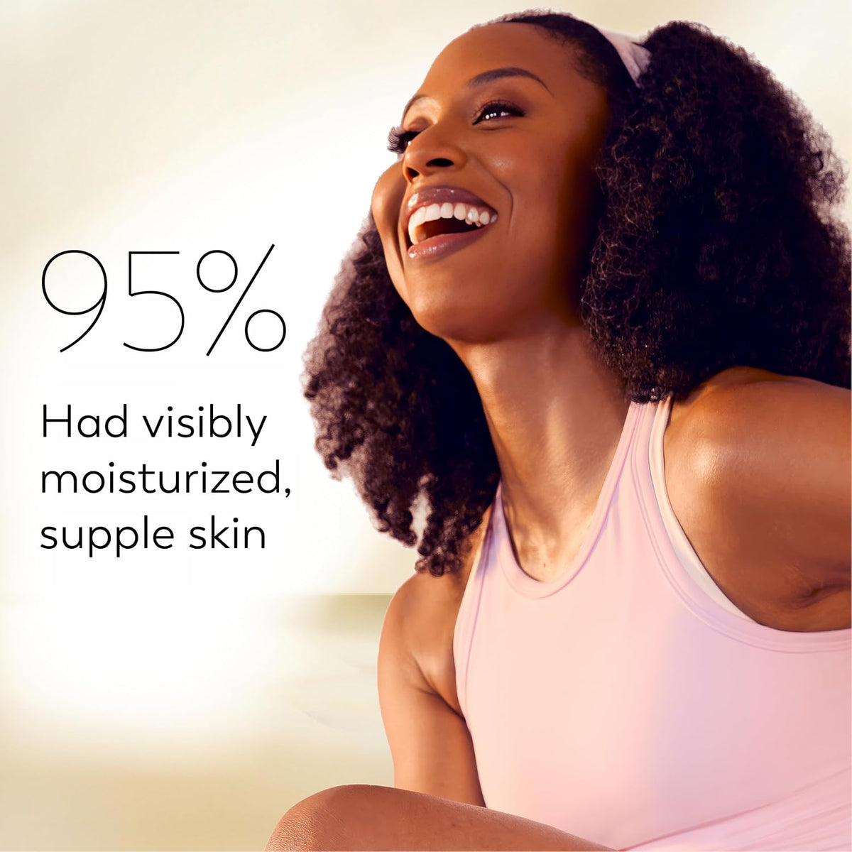 A smiling woman with curly hair wearing a light pink tank top is shown against a soft cream background with promotional text reading '95% Had visibly moisturized, supple skin.'.