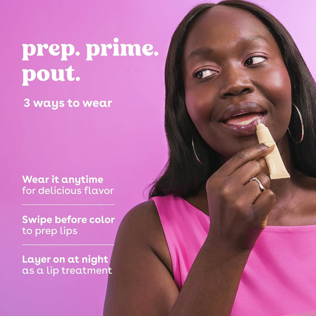 A woman in a bright pink top applies a beige lip product to her lips against a solid pink background, with white text on the left reading 'prep. prime.