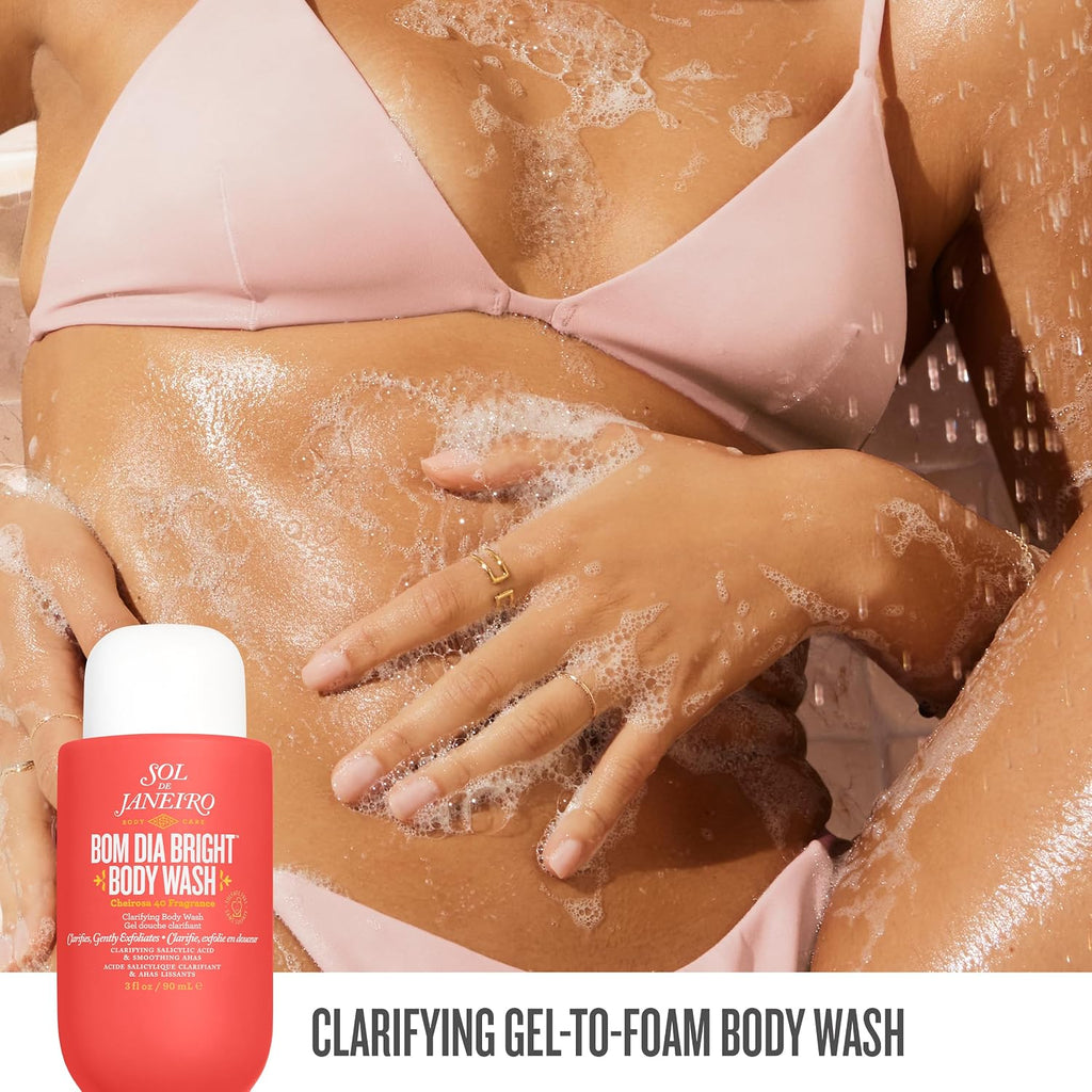 Person applying body wash to their skin with a bottle of Sol de Janeiro body wash in the foreground.