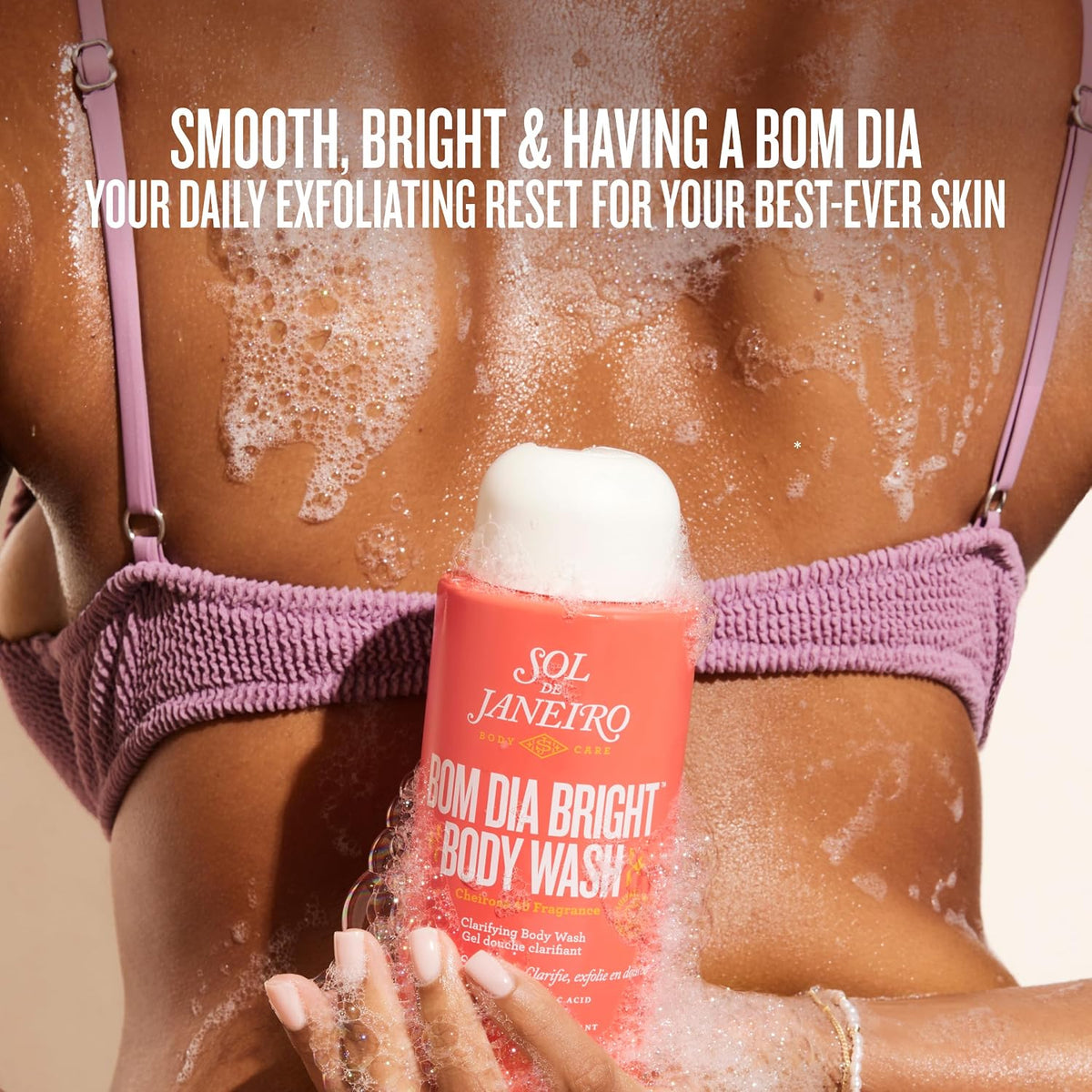 Person using Sol de Janeiro Bom Dia Bright Body Wash with text about skin care benefits.
