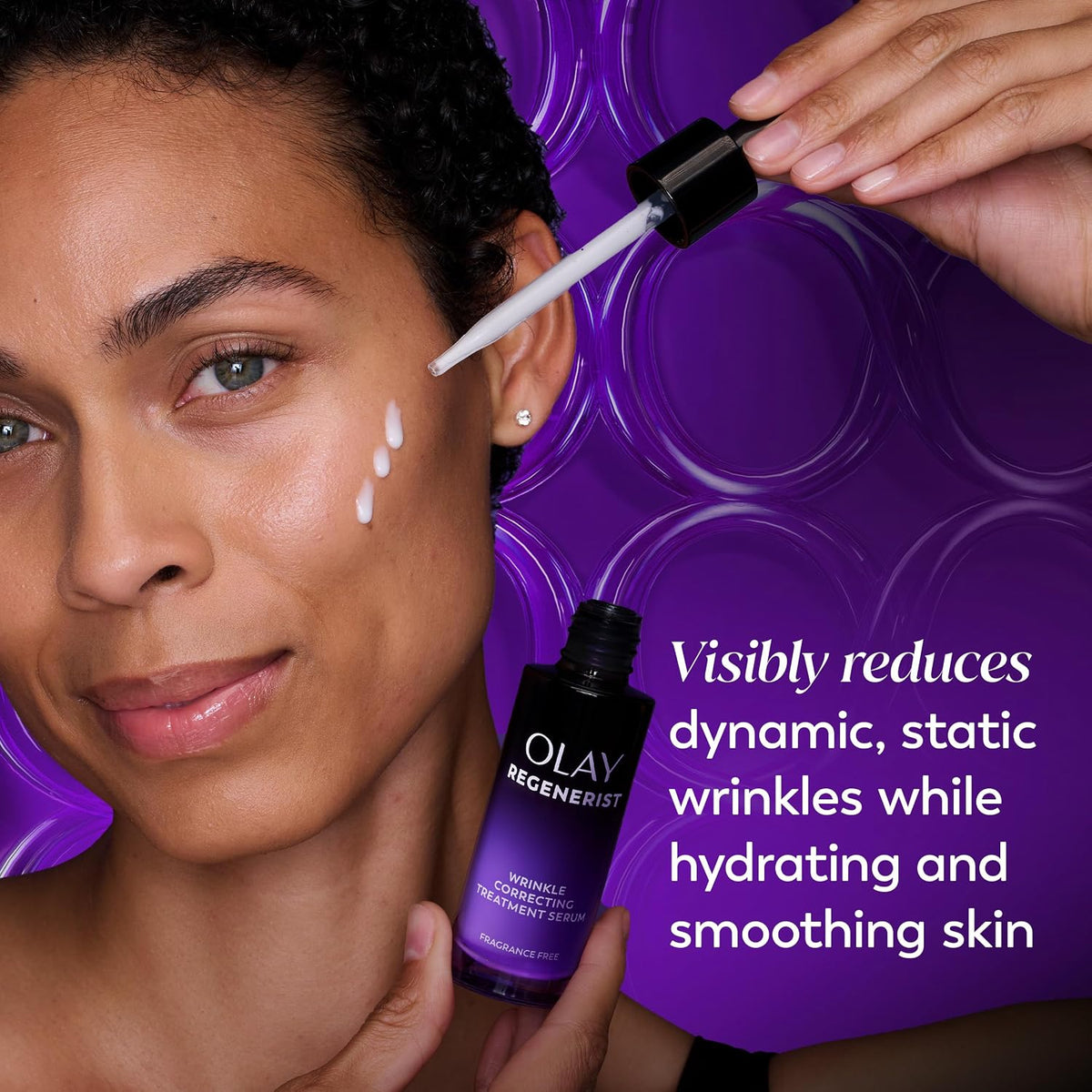 Woman applying Olay Regenerist serum to her face with a purple background