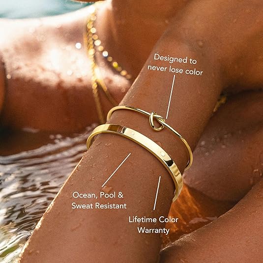 Gold bracelet on a wrist with water in the background, highlighting features like color resistance and warranty.