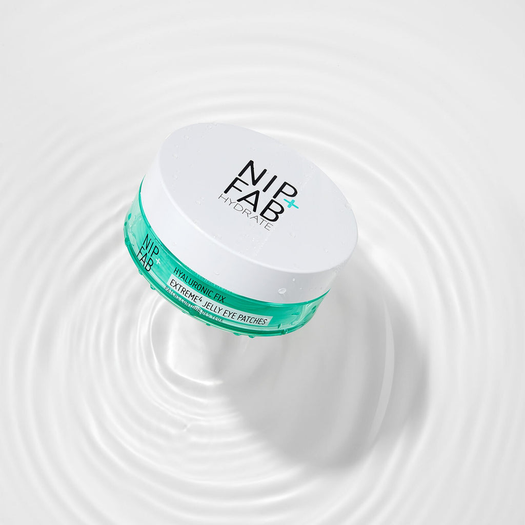 A white cosmetic jar labeled NIPFAB HYDRATE Extreme Eye Parasols, featuring a teal band around the middle, set against a white background with water ripples.
