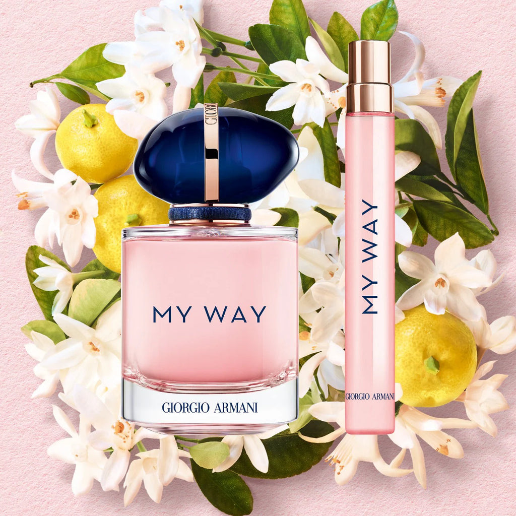 Giorgio Armani 'My Way' perfume set with flowers and lemons on a pink background