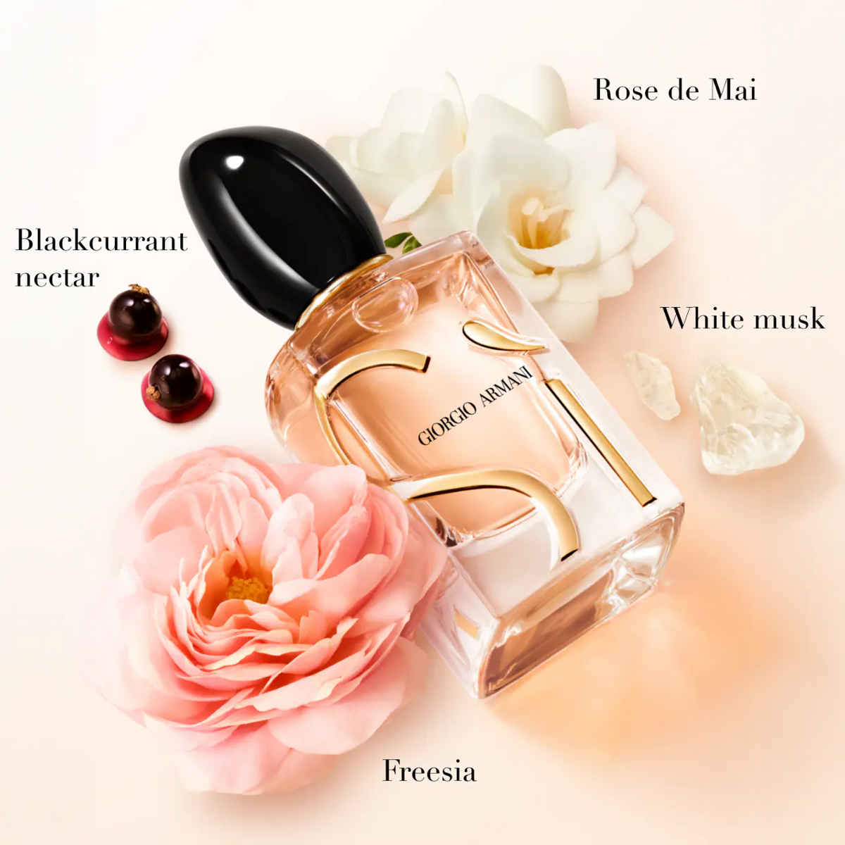 Giorgio Armani perfume bottle with flowers and berries on a light background