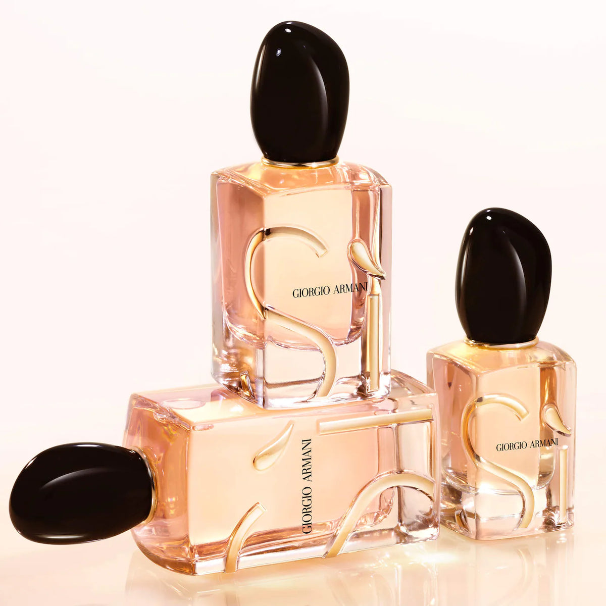 Three Giorgio Armani perfume bottles on a white background
