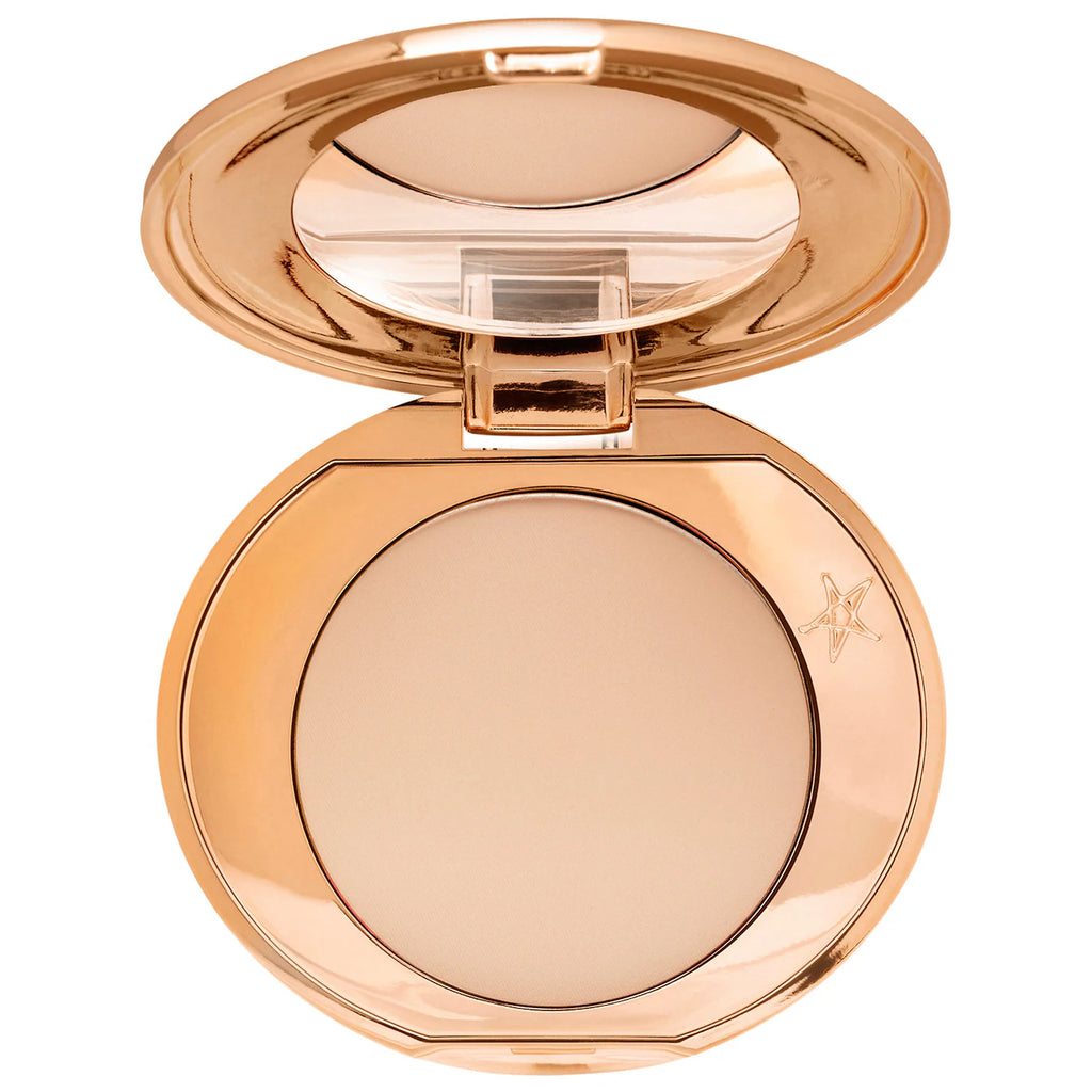Compact powder in a rose gold case on a white background