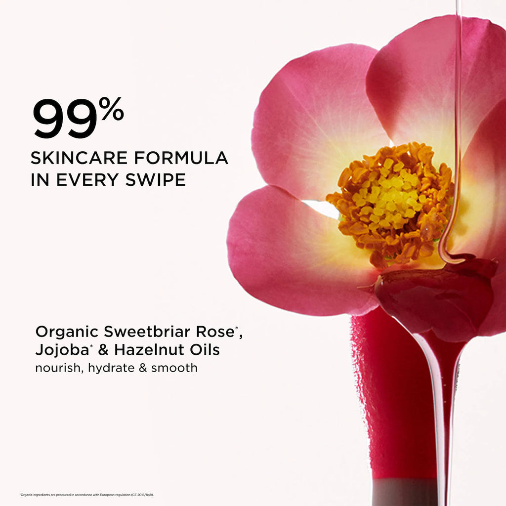 Product packaging with a pink flower and oil droplet, featuring text about skincare formula and oils.