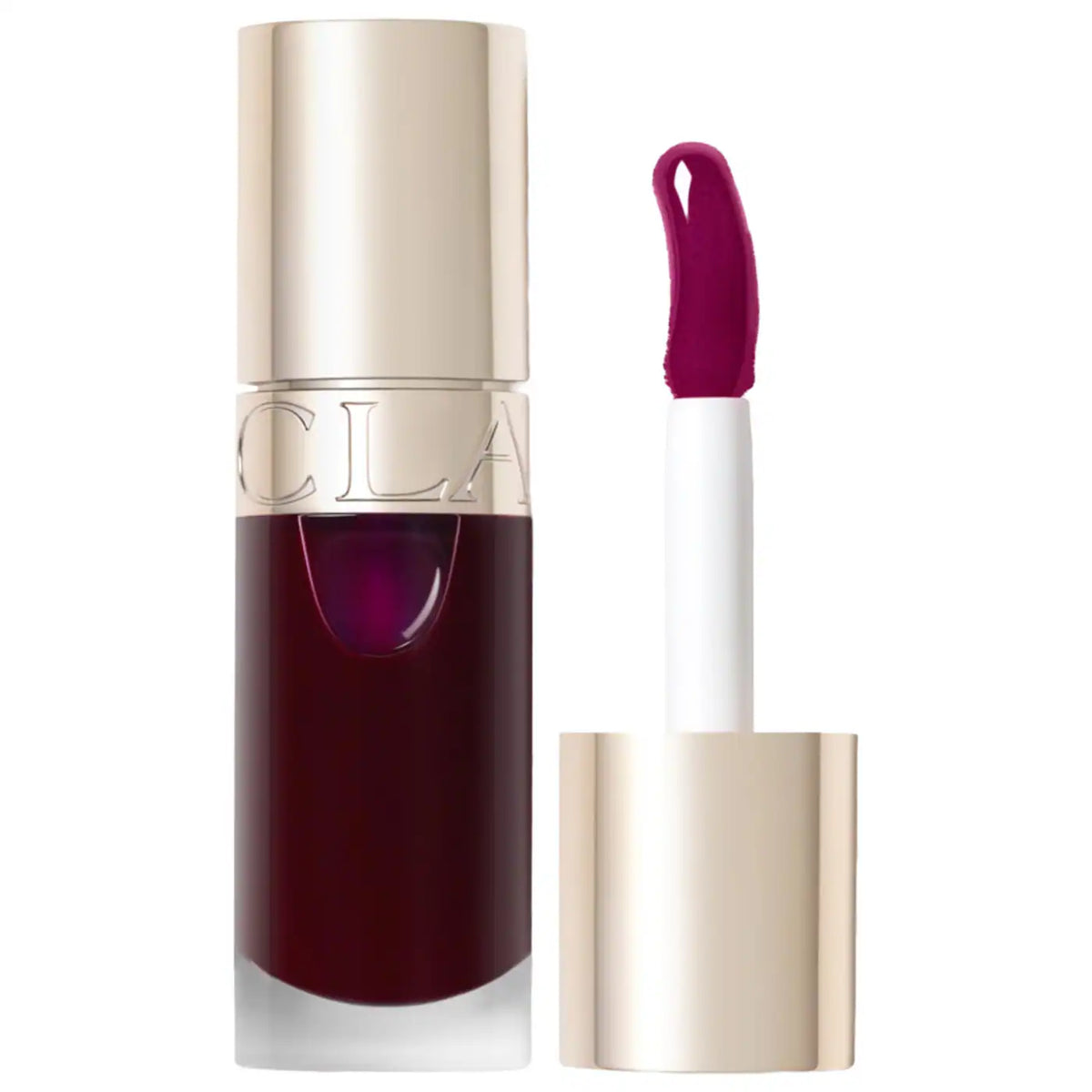 A bottle of liquid lipstick with a metallic gold cap and a doe-foot applicator showing a deep berry purple shade, set against a plain white background.