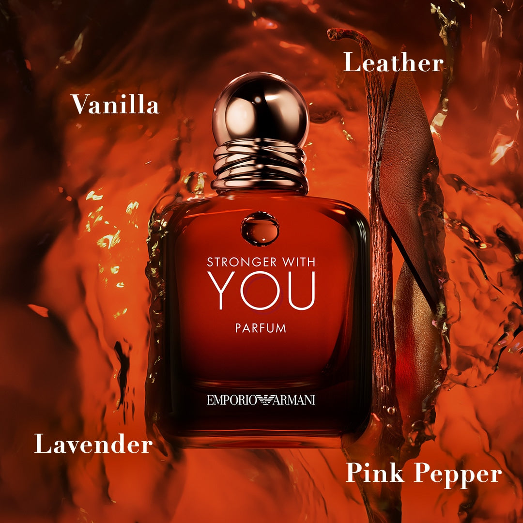 Red perfume bottle labeled 'Stronger with You' by Emporio Armani on a textured red background.