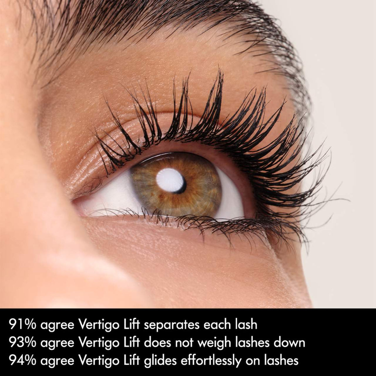Close-up of an eye with long, well-groomed eyelashes on a neutral background