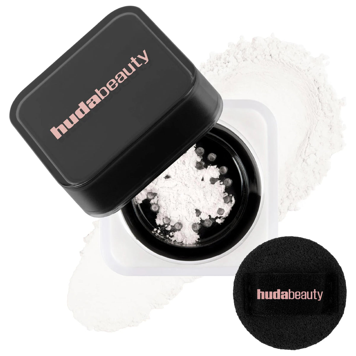 Huda Beauty powder with black lid and sponge on a white background