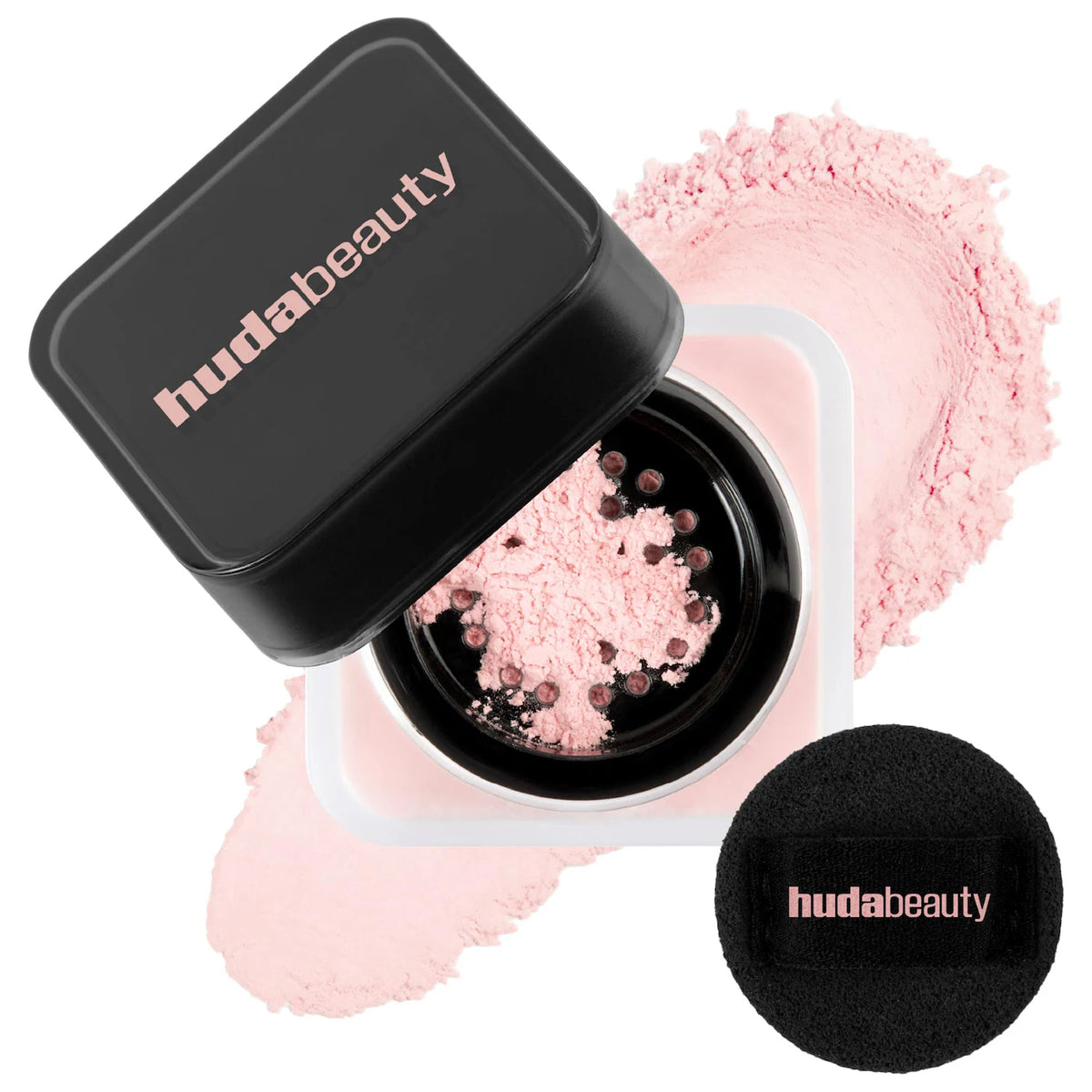 Huda Beauty compact with pink powder and black sponge on a white background