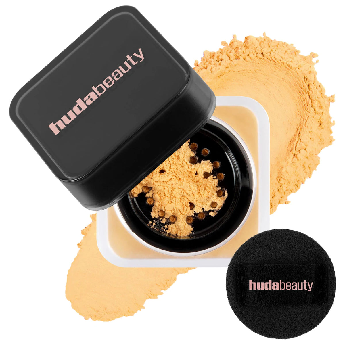 Huda Beauty powder with black lid and black sponge applicator on a white background