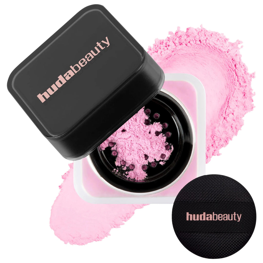Huda Beauty compact with pink powder and black lid on a white background