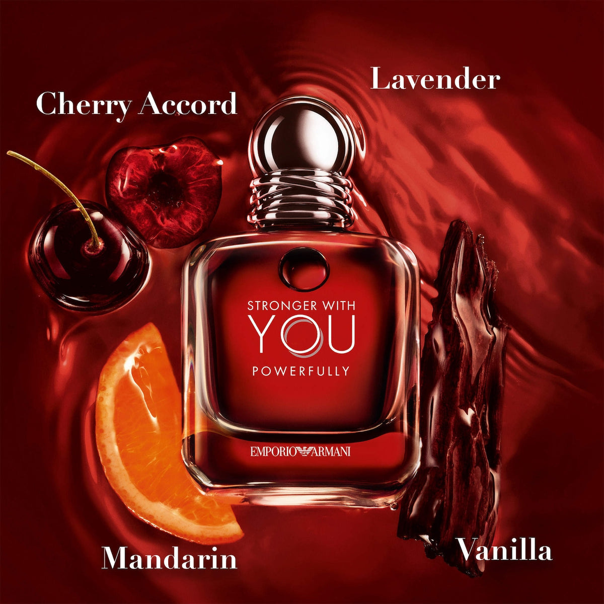 Red Emporio Armani perfume bottle with fruit elements on a red background