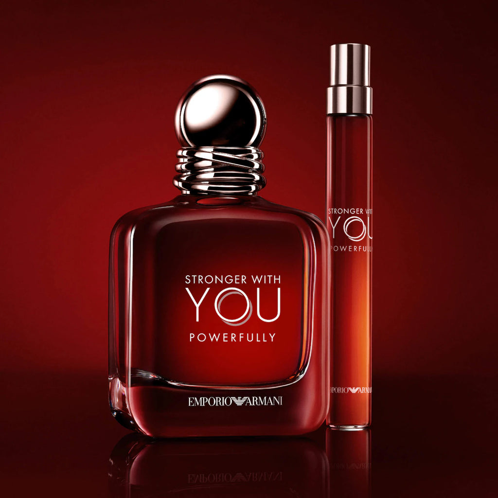 Red perfume bottle and smaller spray bottle with 'Stronger With You' text on a red background
