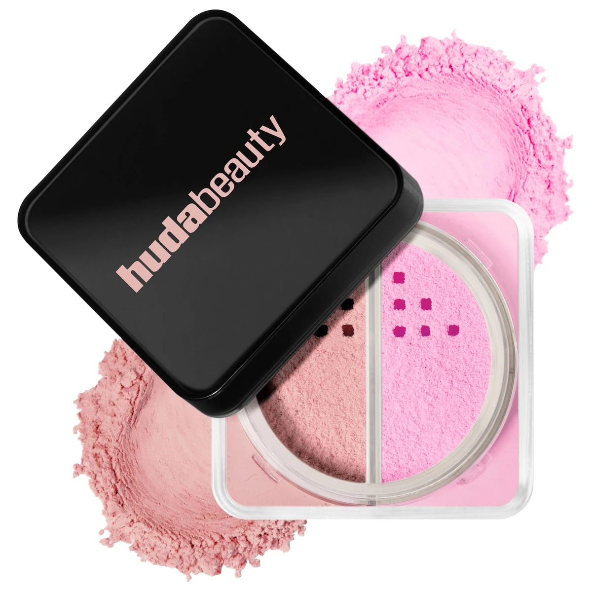 Huda Beauty two-pan blush compact shown open with the black lid leaning on top, revealing pink and peach powder pans, with loose pink powder scattered behind it on a white background.