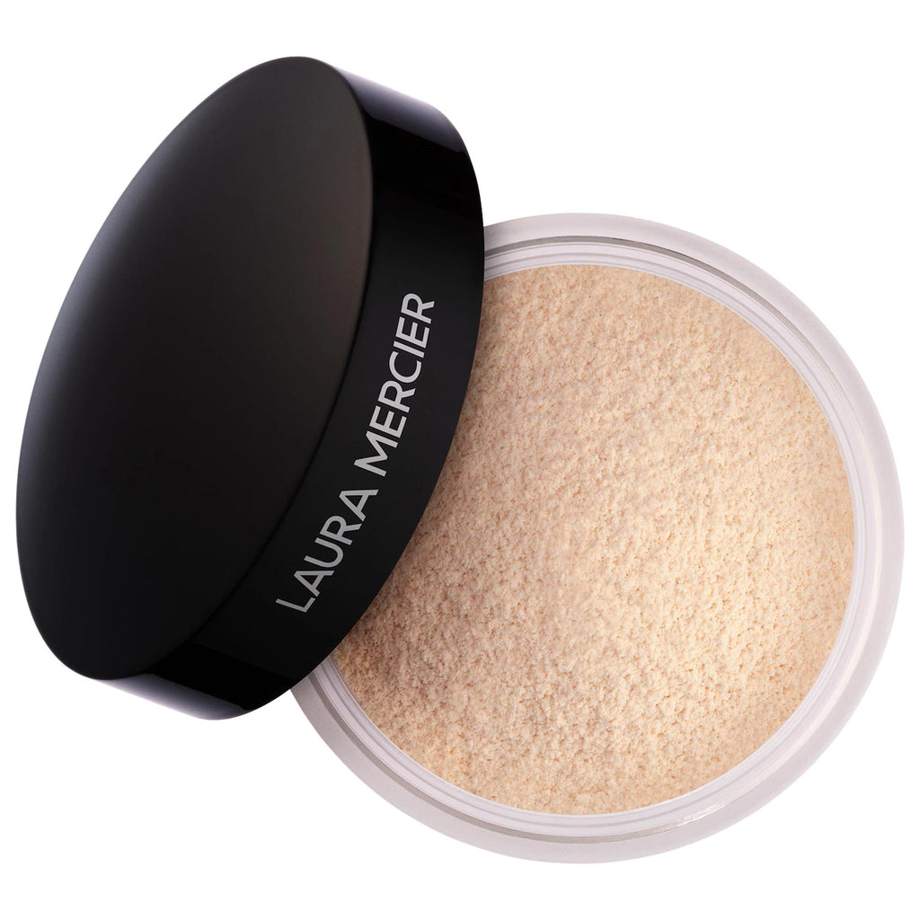 Laura Mercier powder compact with black lid on a white background
